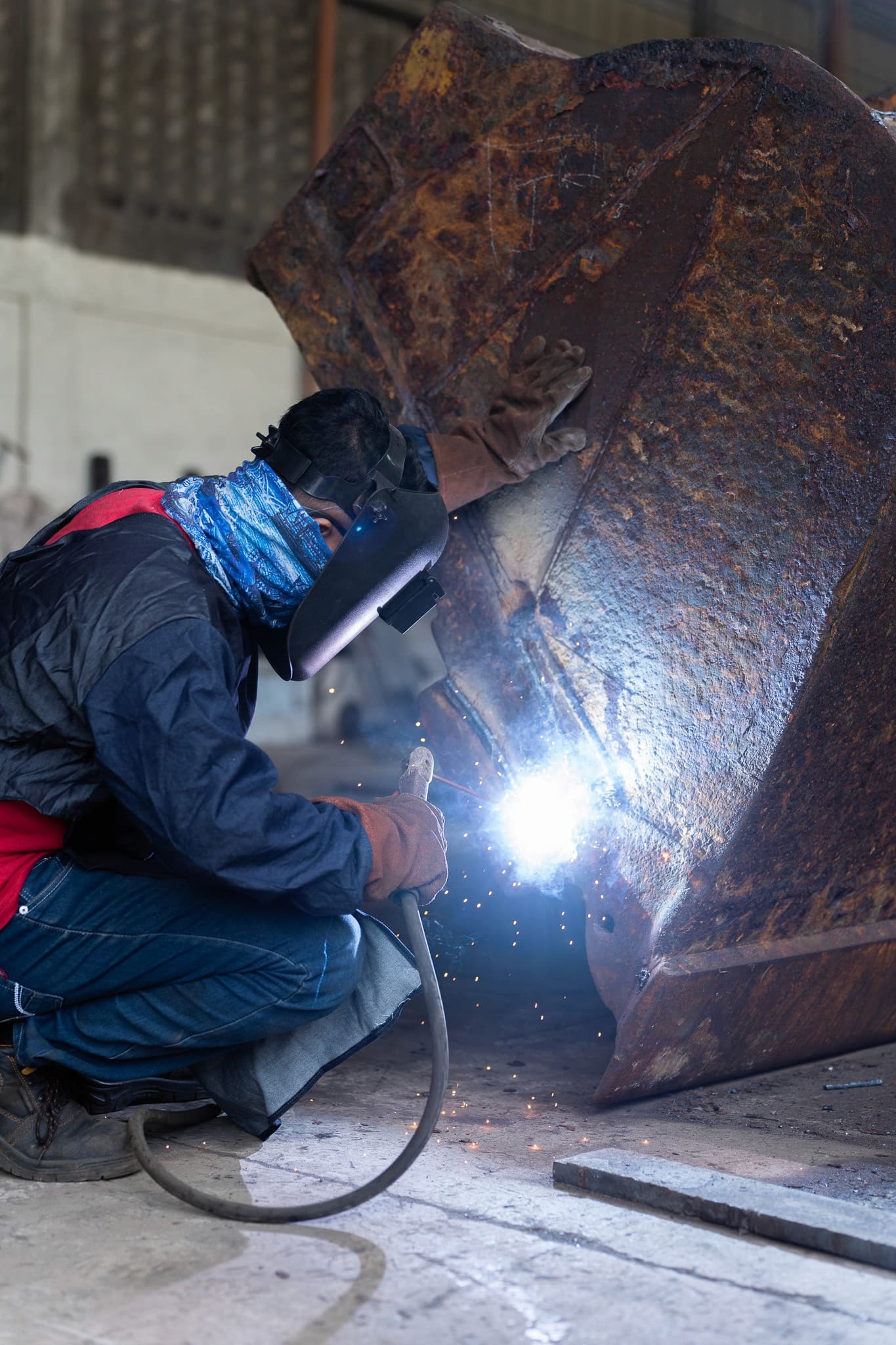 A Rock Gold technician welding an excavator bucket